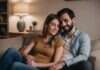 How to Reconnect with Your Partner After Work Stress? The Signs to Look For Before You Make Your Next Move Two adults resting closely together and holding hands on a sofa.