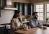 Common Reasons Long-term Couples Fight: The Small Shift That Can Stop the Same Fight From Coming Back Two adults smiling together at a kitchen table with plain cups.