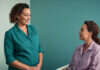 Medical Autonomy and Relationship Control Over Healthcare Choices Two women discussing healthcare choices in a plain clinic room.