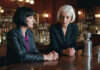 Workplace Power, Tip Disputes, and Exploitation in Nightlife Jobs Two women having a serious conversation at an unlettered bar counter.