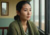 The Hidden Reason You Keep Falling for Emotionally Unavailable Men Woman sitting quietly beside a bright window.