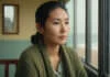 The Hidden Reason You Keep Falling for Emotionally Unavailable Men Woman sitting quietly beside a bright window.