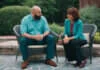 Intimacy and Communication: Why Connection Fades—and How Couples Can Find It Again Two adults having a thoughtful conversation in a green courtyard.