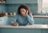 Texts with My Situationship Trend: How to Read the Signs Before You Waste Another Month A woman reflecting beside a blank tablet in a quiet kitchen.