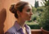 Wellness vs Wellbeing: Practical Distinctions A woman reflecting on a quiet courtyard terrace.