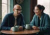 Intimacy After Infidelity: How to Rebuild Safety Without Becoming the Relationship Detective Two partners sharing a conversation over plain cups at home.
